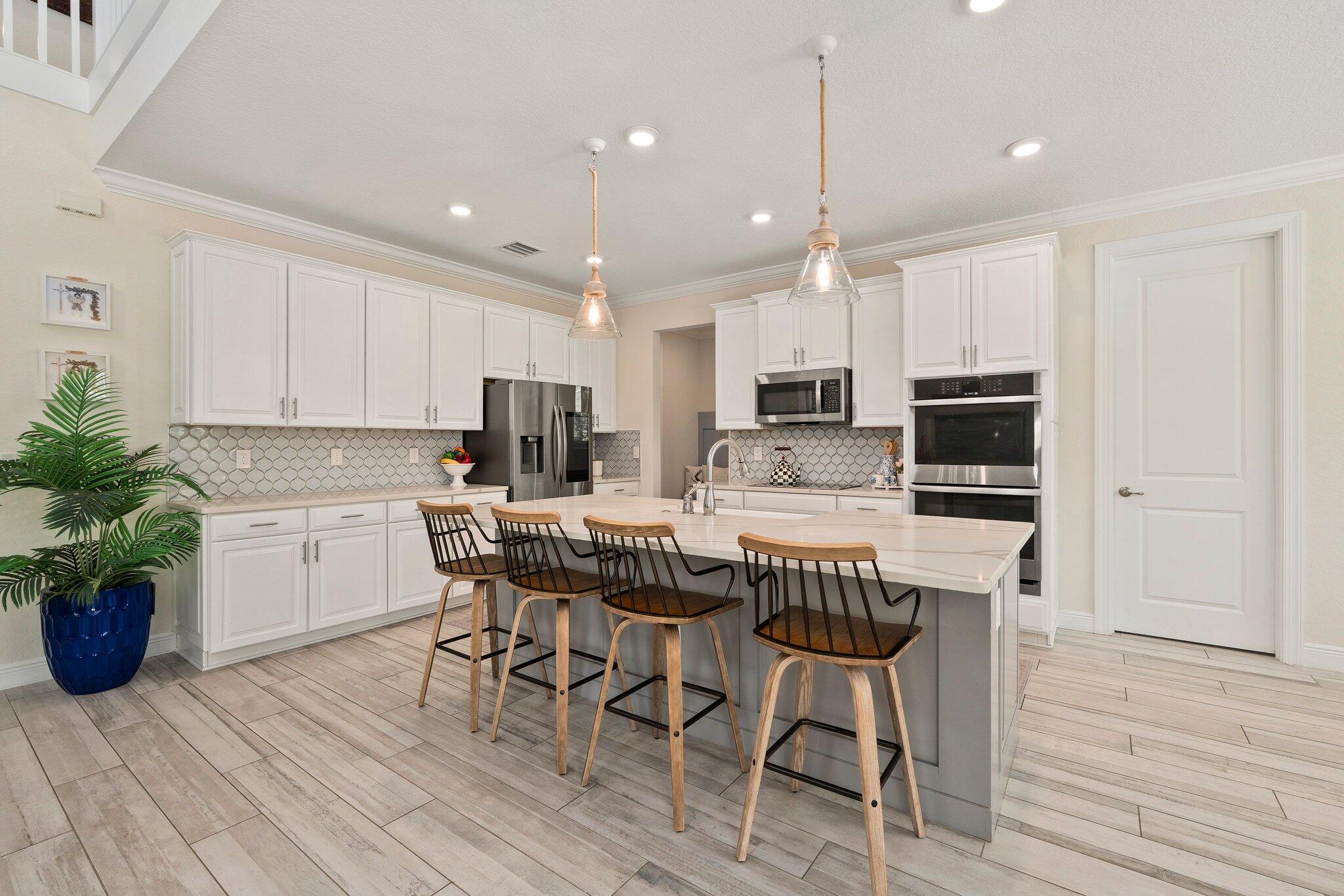 4701 Southwest Ardsley Drive Stuart, FL 34997 - Photo 18 of 83 a kitchen with a table chairs microwave and cabinets