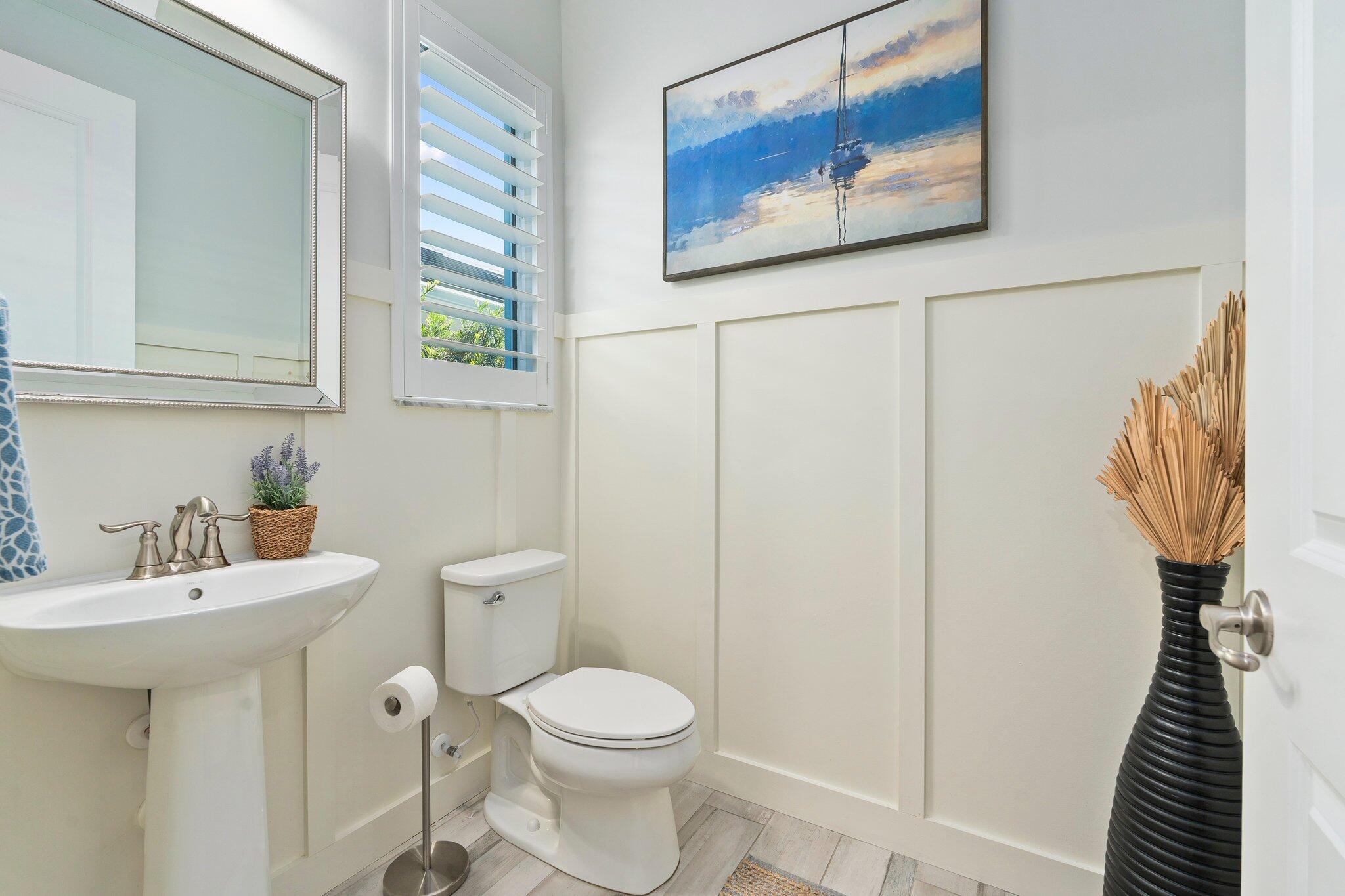 4701 Southwest Ardsley Drive Stuart, FL 34997 - Photo 23 of 83 a white toilet sitting next to a bathroom sink