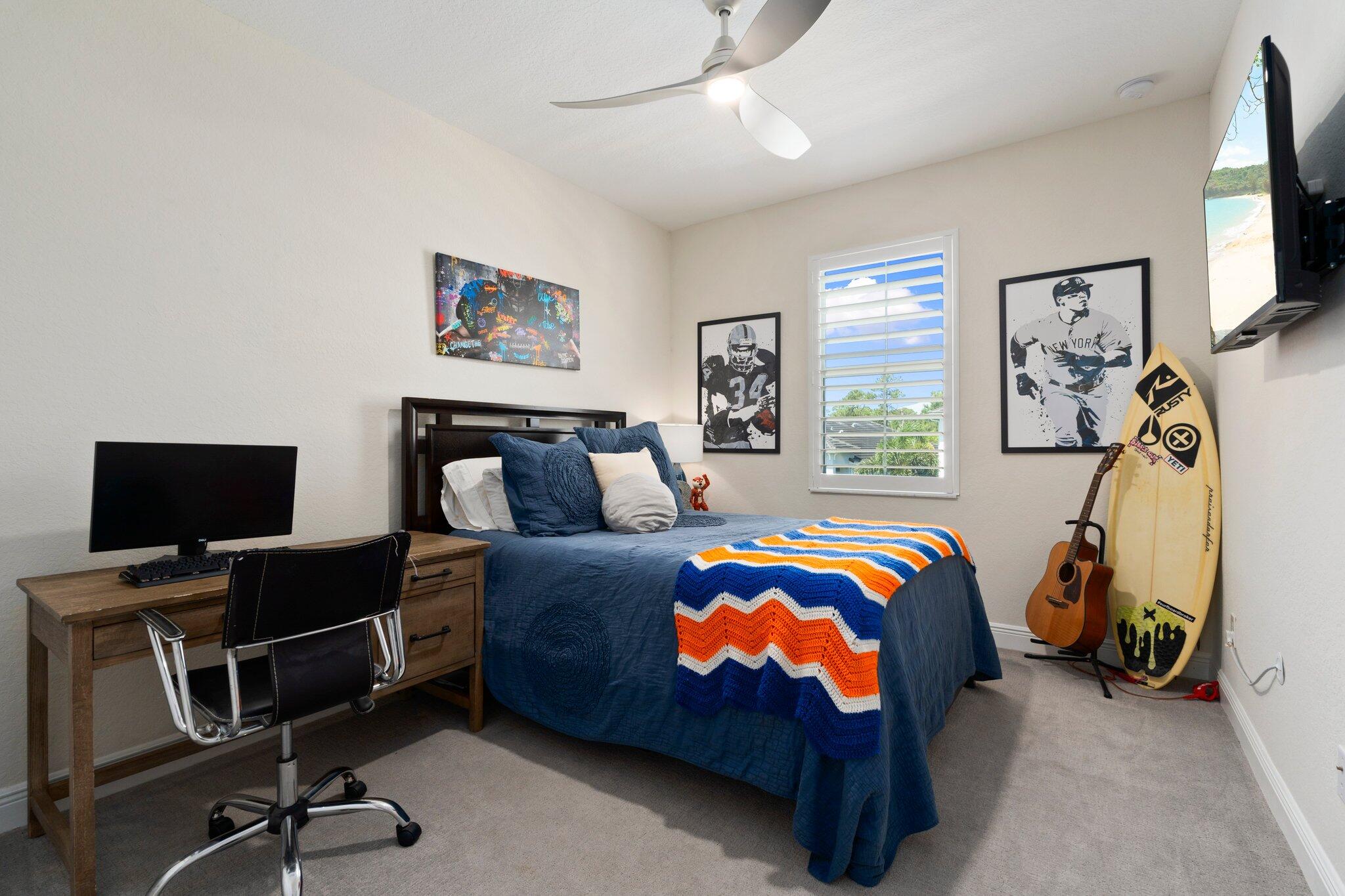 4701 Southwest Ardsley Drive Stuart, FL 34997 - Photo 43 of 83 a bedroom with a bed and a flat screen tv