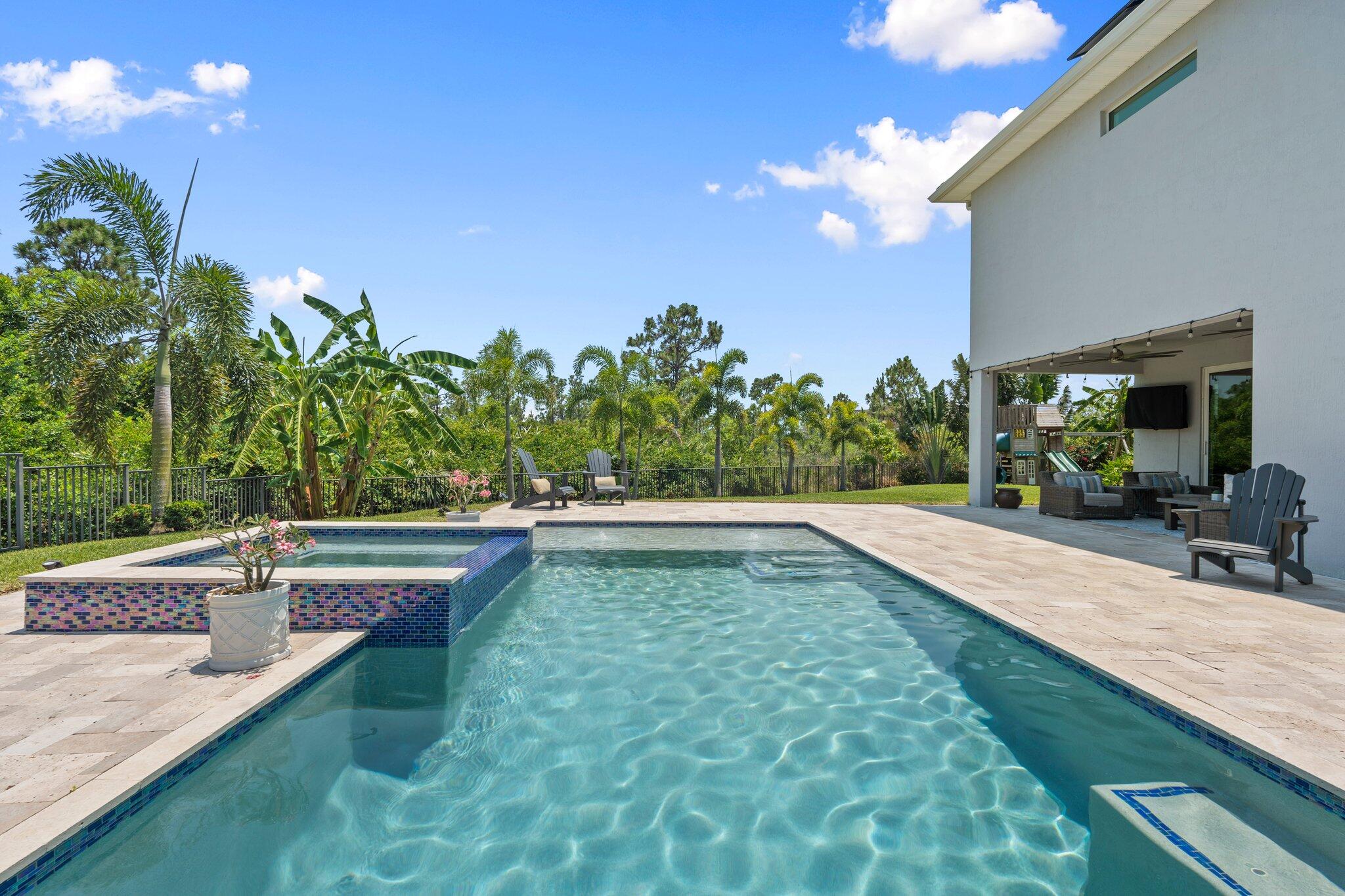 4701 Southwest Ardsley Drive Stuart, FL 34997 - Photo 50 of 83 a view of a swimming pool with a patio