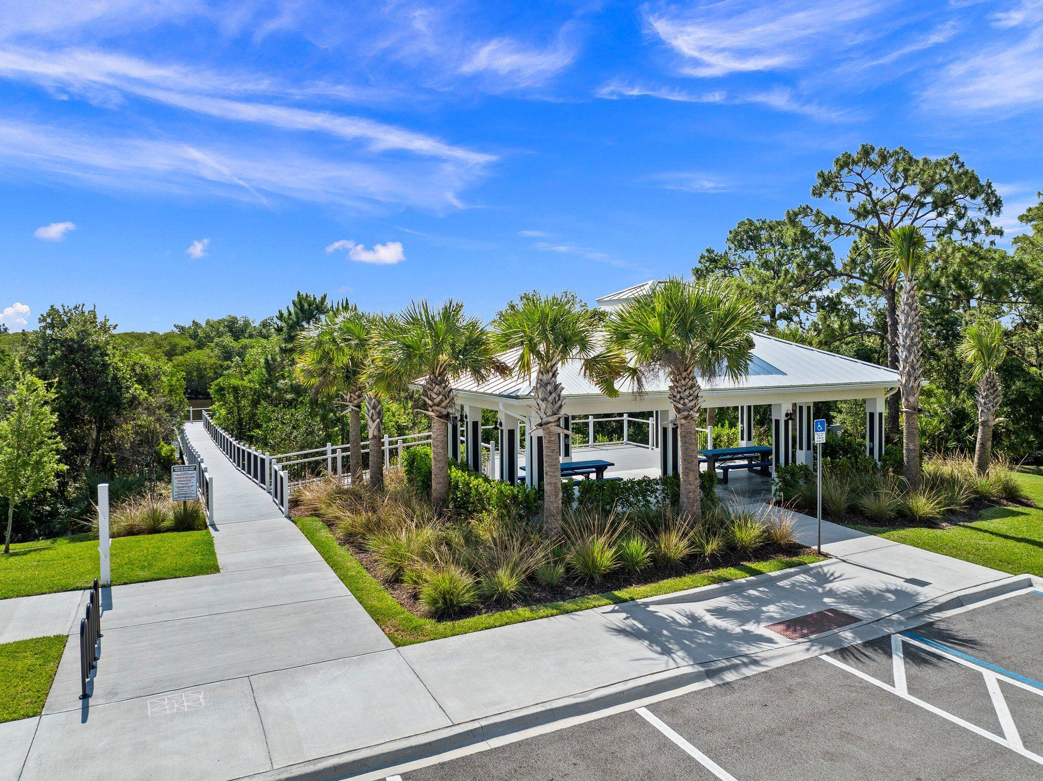 4701 Southwest Ardsley Drive Stuart, FL 34997 - Photo 69 of 83 a view of a patio with a table and chairs under an umbrella