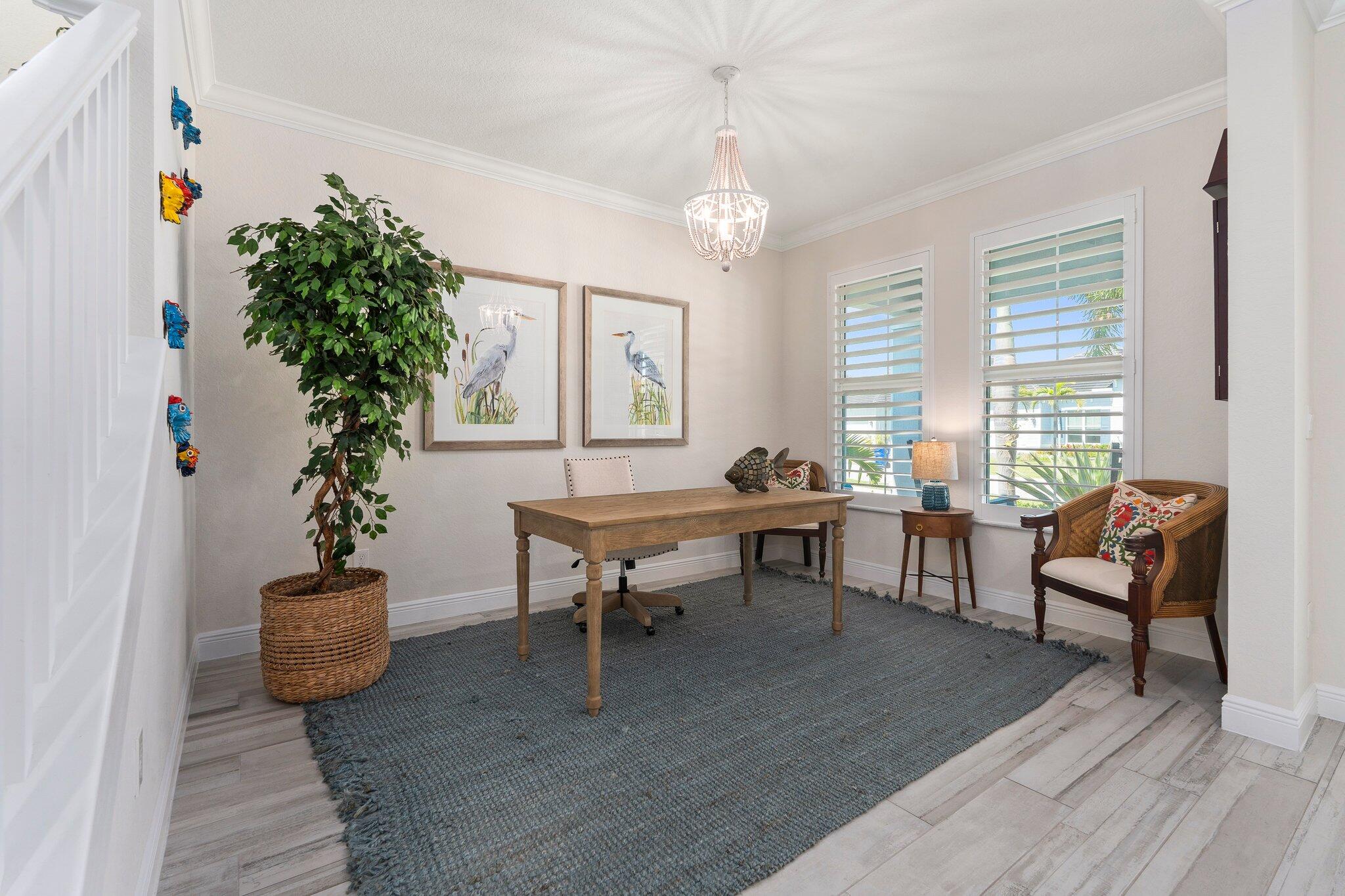 4701 Southwest Ardsley Drive Stuart, FL 34997 - Photo 7 of 83 a living room with furniture a window and a potted plant