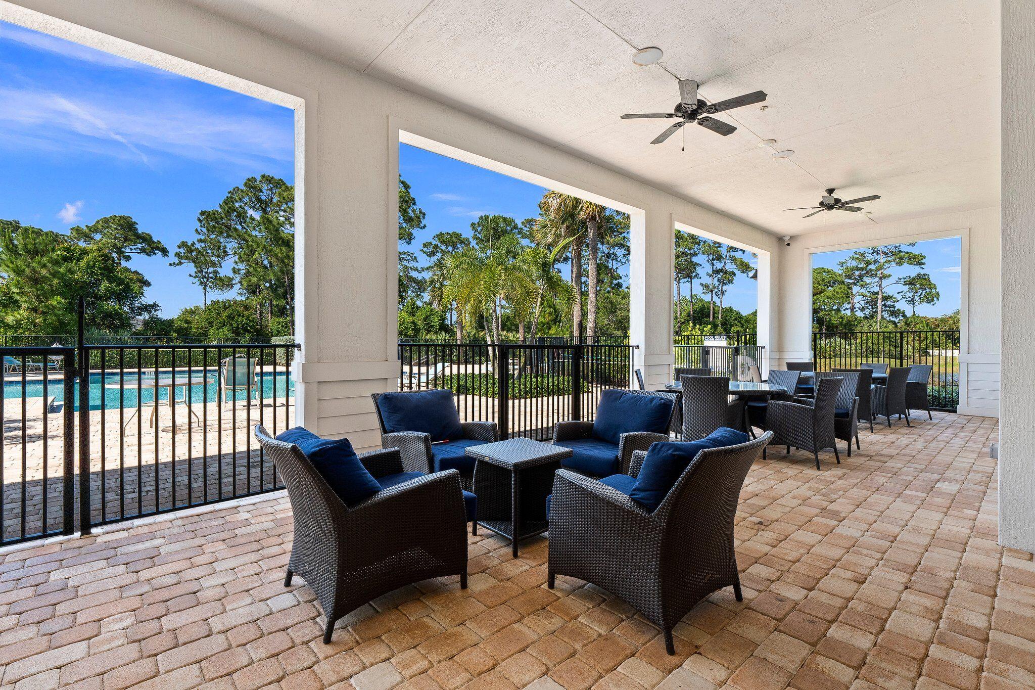 4701 Southwest Ardsley Drive Stuart, FL 34997 - Photo 82 of 83 a living room with furniture and a floor to ceiling window