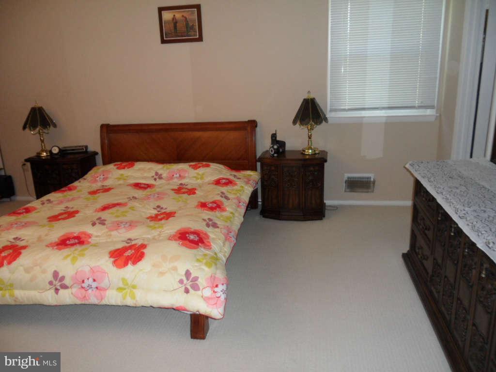 15200 Watergate Road Silver Spring, MD 20905 - Photo 13 of 22 a bedroom with a bed and a dresser