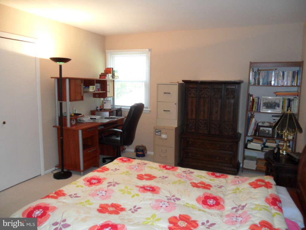 15200 Watergate Road Silver Spring, MD 20905 - Photo 14 of 22 a bedroom with a bed and cabinets
