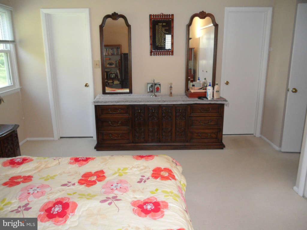 15200 Watergate Road Silver Spring, MD 20905 - Photo 15 of 22 a bedroom with a bed and a dresser