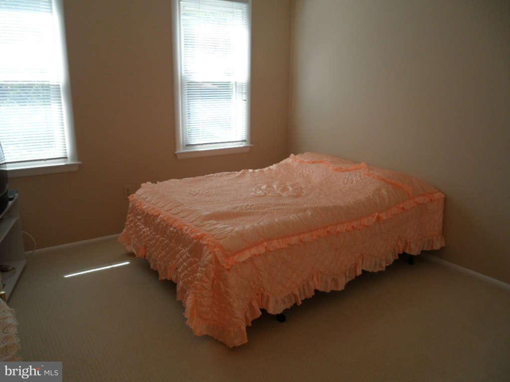 15200 Watergate Road Silver Spring, MD 20905 - Photo 17 of 22 a bed sitting in a bedroom next to a window