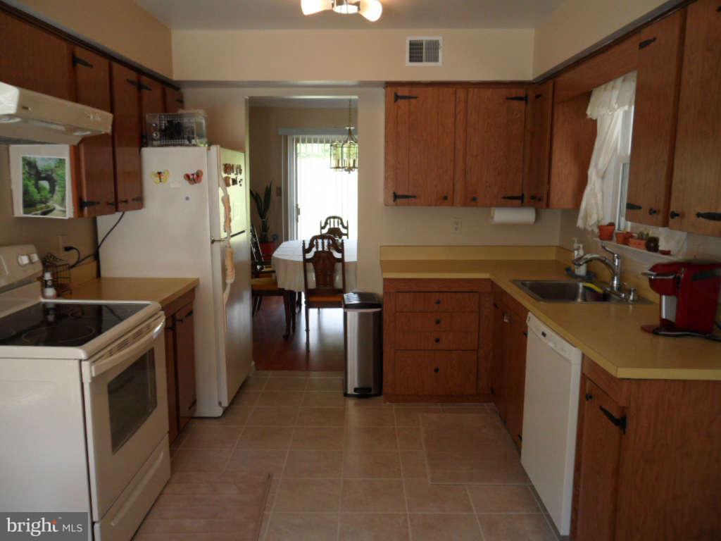 15200 Watergate Road Silver Spring, MD 20905 - Photo 3 of 22 a kitchen with a sink stove and cabinets
