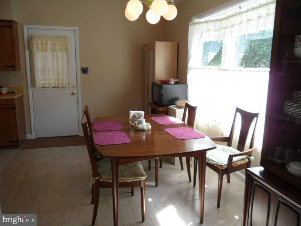 15200 Watergate Road Silver Spring, MD 20905 - Photo 6 of 22 a view of a dining room with furniture and wooden floor