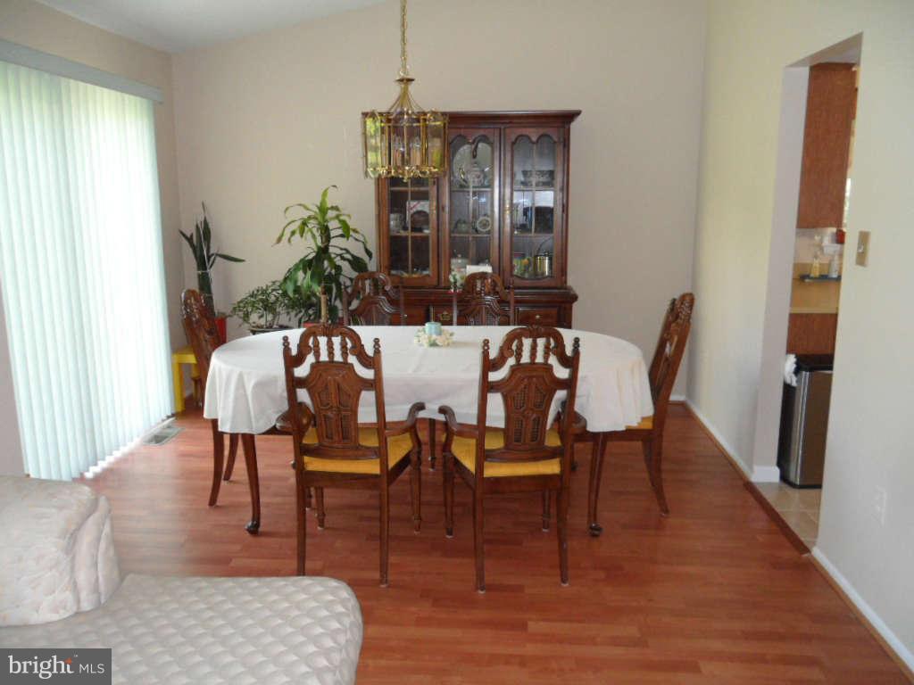 15200 Watergate Road Silver Spring, MD 20905 - Photo 10 of 22 a view of a dining room with furniture and wooden floor