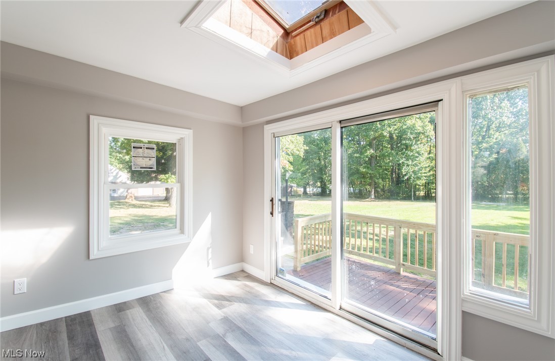 1097 South Meridian Road Youngstown, OH 44511 - Photo 15 of 29 Hardwood floored empty room with a skylight and a wealth of natural light