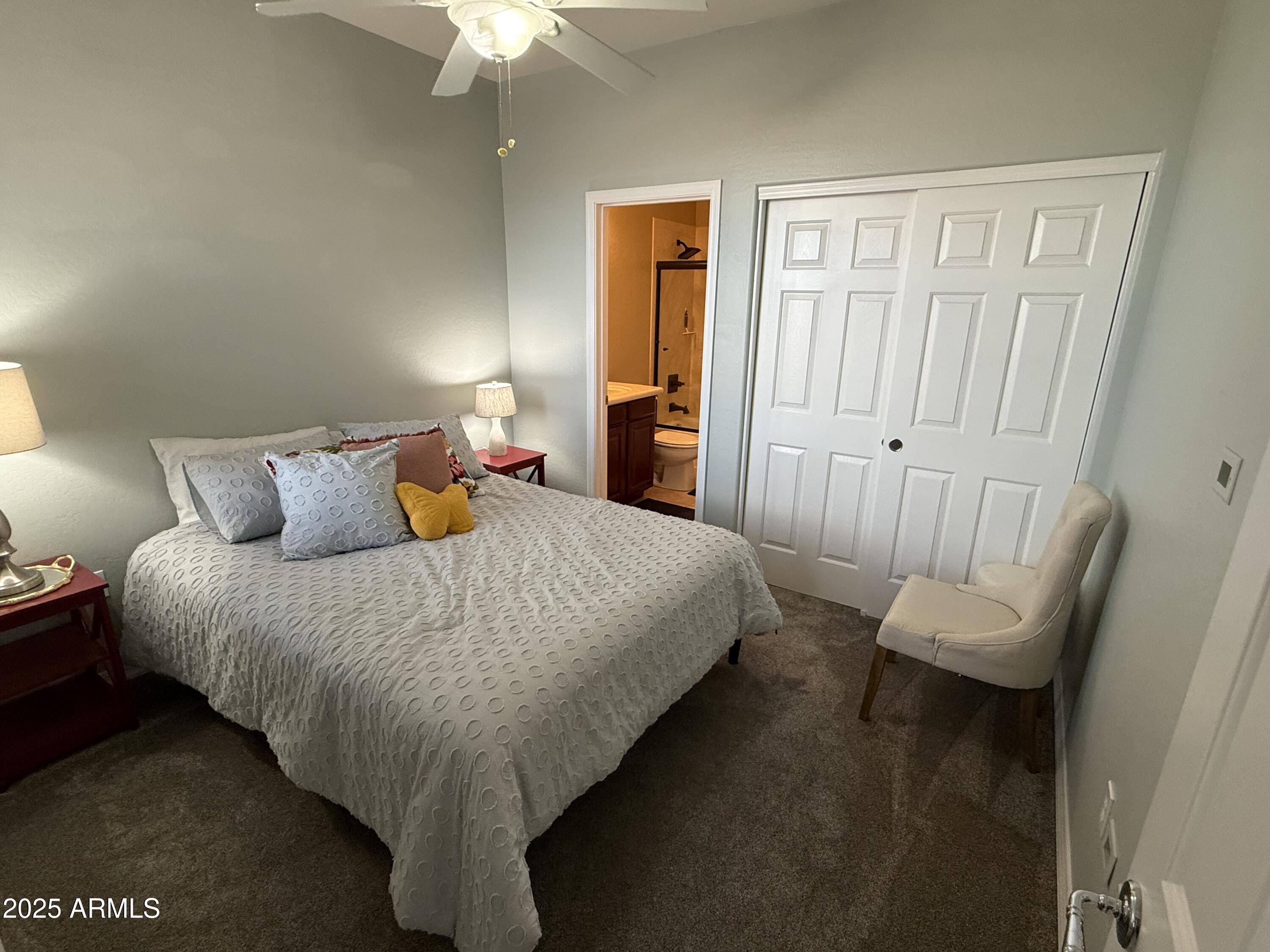 3935 East Rough Rider Road, Unit 1014 Phoenix, AZ 85050 - Photo 11 of 40 a bed sitting in a bedroom next to a window