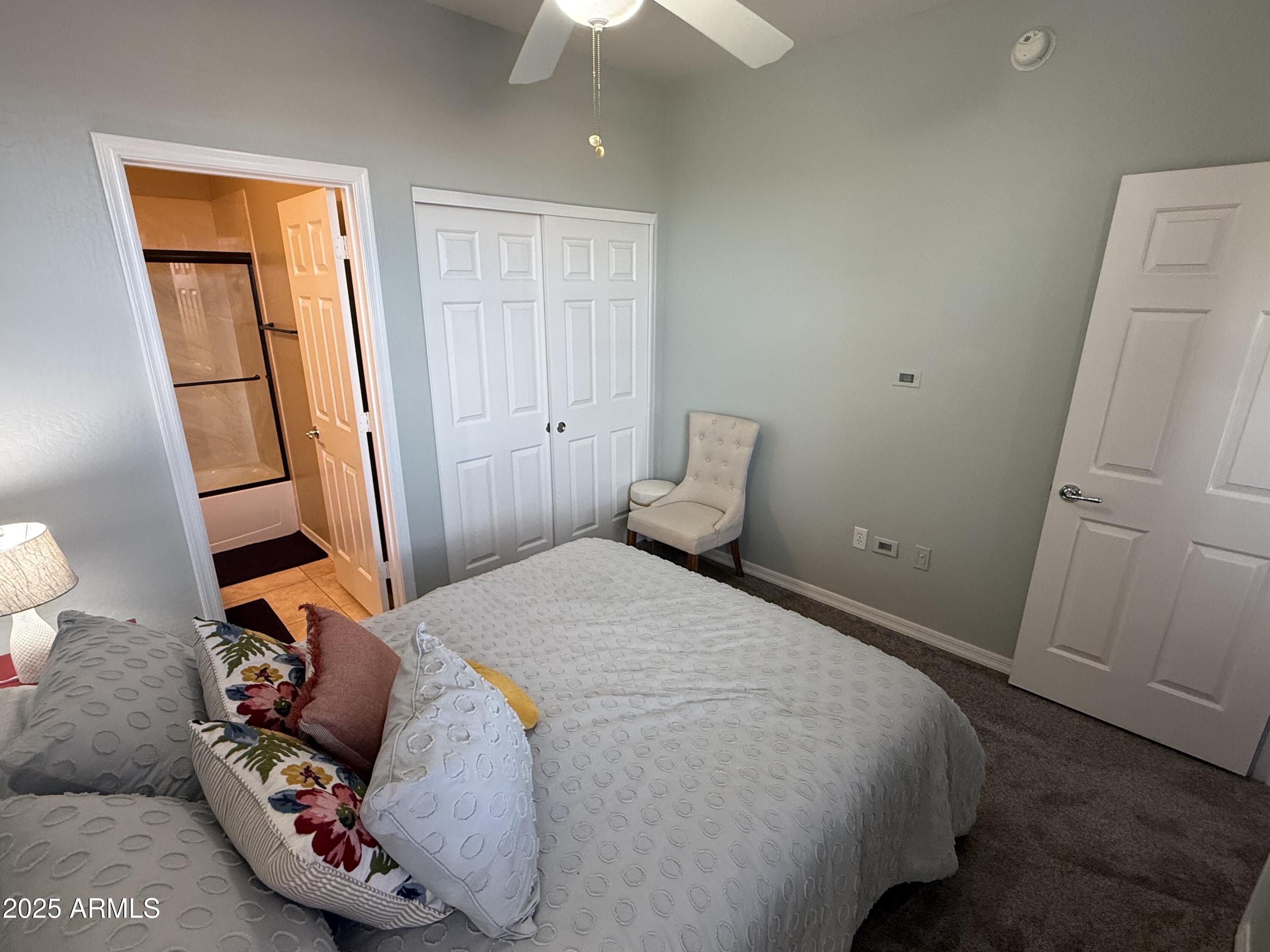 3935 East Rough Rider Road, Unit 1014 Phoenix, AZ 85050 - Photo 13 of 40 a bedroom with a bed and a window