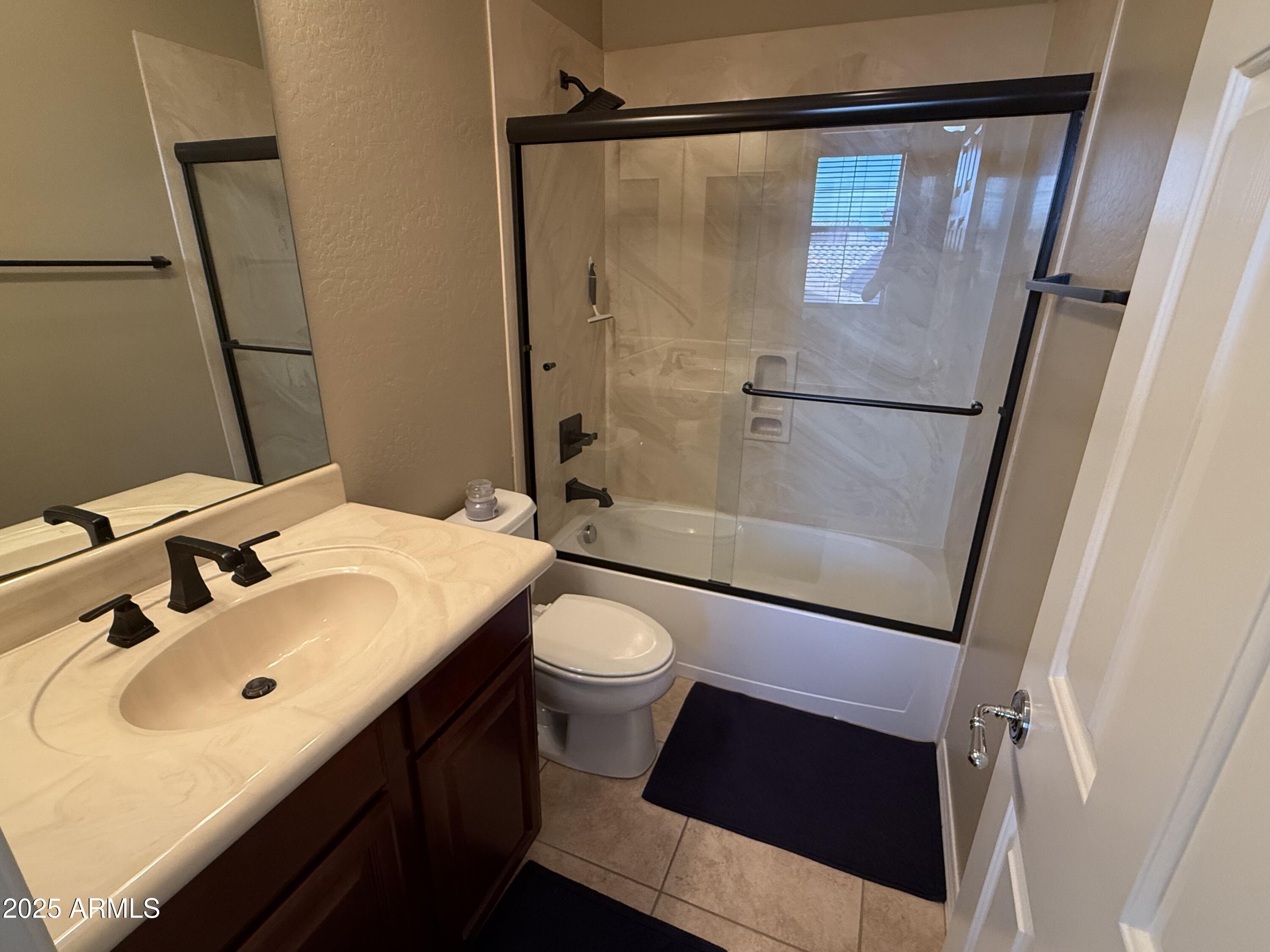 3935 East Rough Rider Road, Unit 1014 Phoenix, AZ 85050 - Photo 14 of 40 a bathroom with a sink a toilet a mirror and shower
