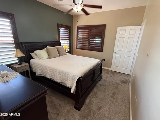 a living room with a bed furniture and a window