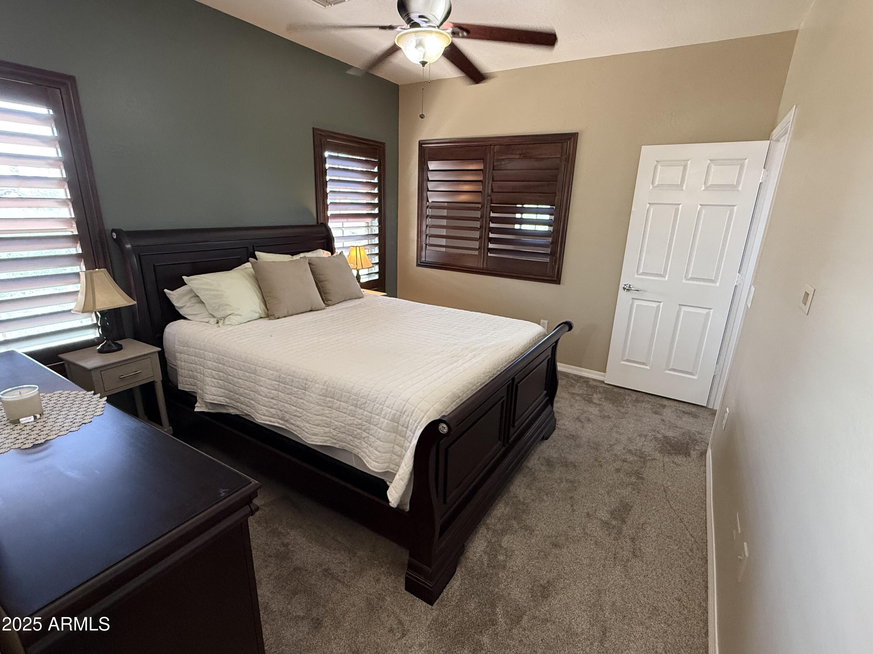 3935 East Rough Rider Road, Unit 1014 Phoenix, AZ 85050 - Photo 16 of 40 a living room with a bed furniture and a window