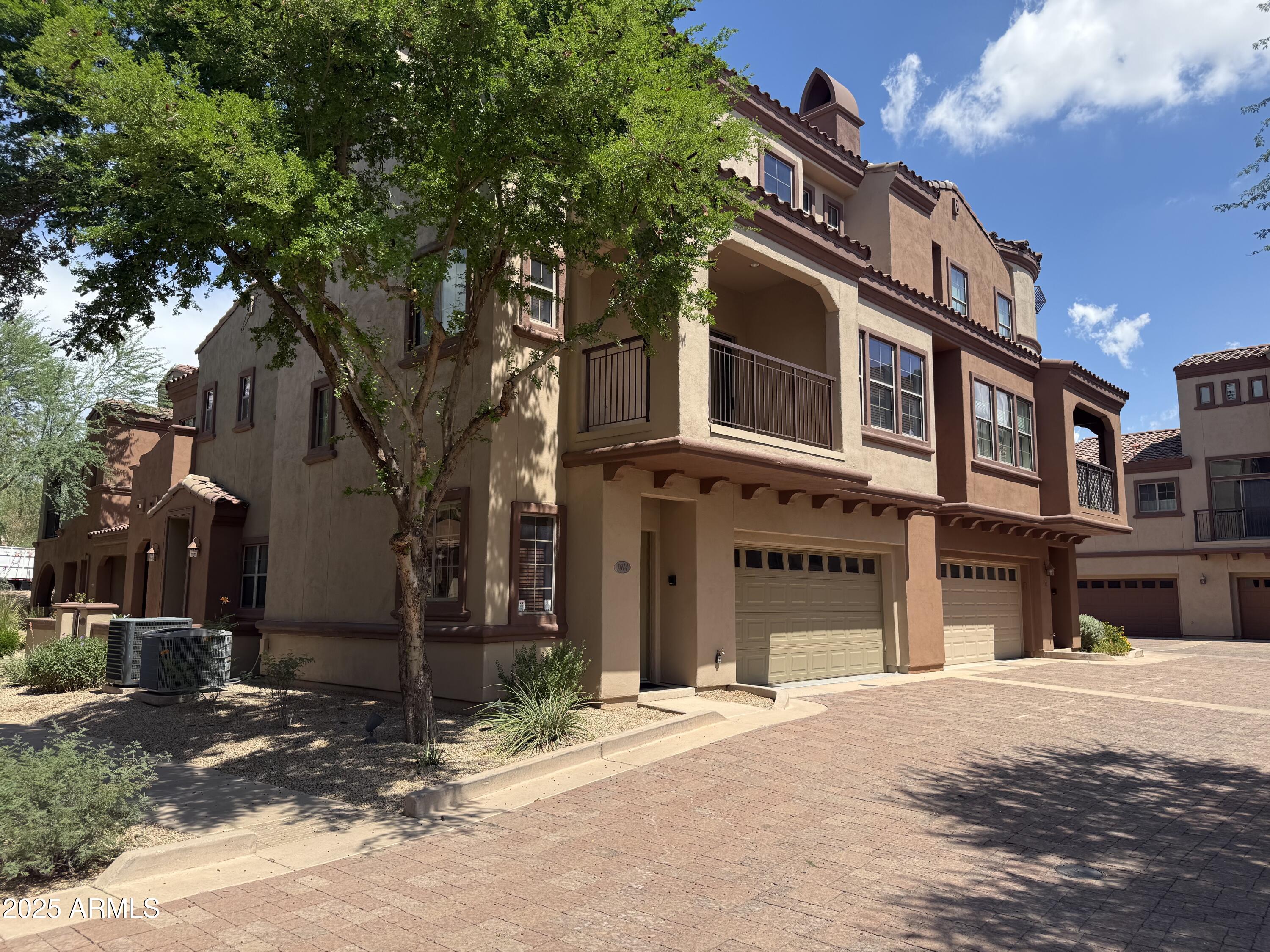3935 East Rough Rider Road, Unit 1014 Phoenix, AZ 85050 - Photo 2 of 40 a front view of a building