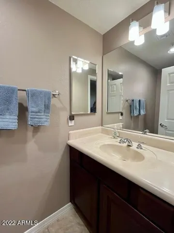 a bathroom with a sink a mirror and a vanity