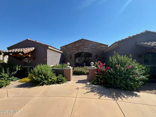 a front view of house with a garden