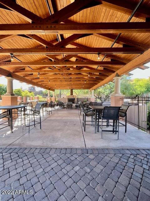 3935 East Rough Rider Road, Unit 1014 Phoenix, AZ 85050 - Photo 36 of 40 a patio with glass top table and chairs