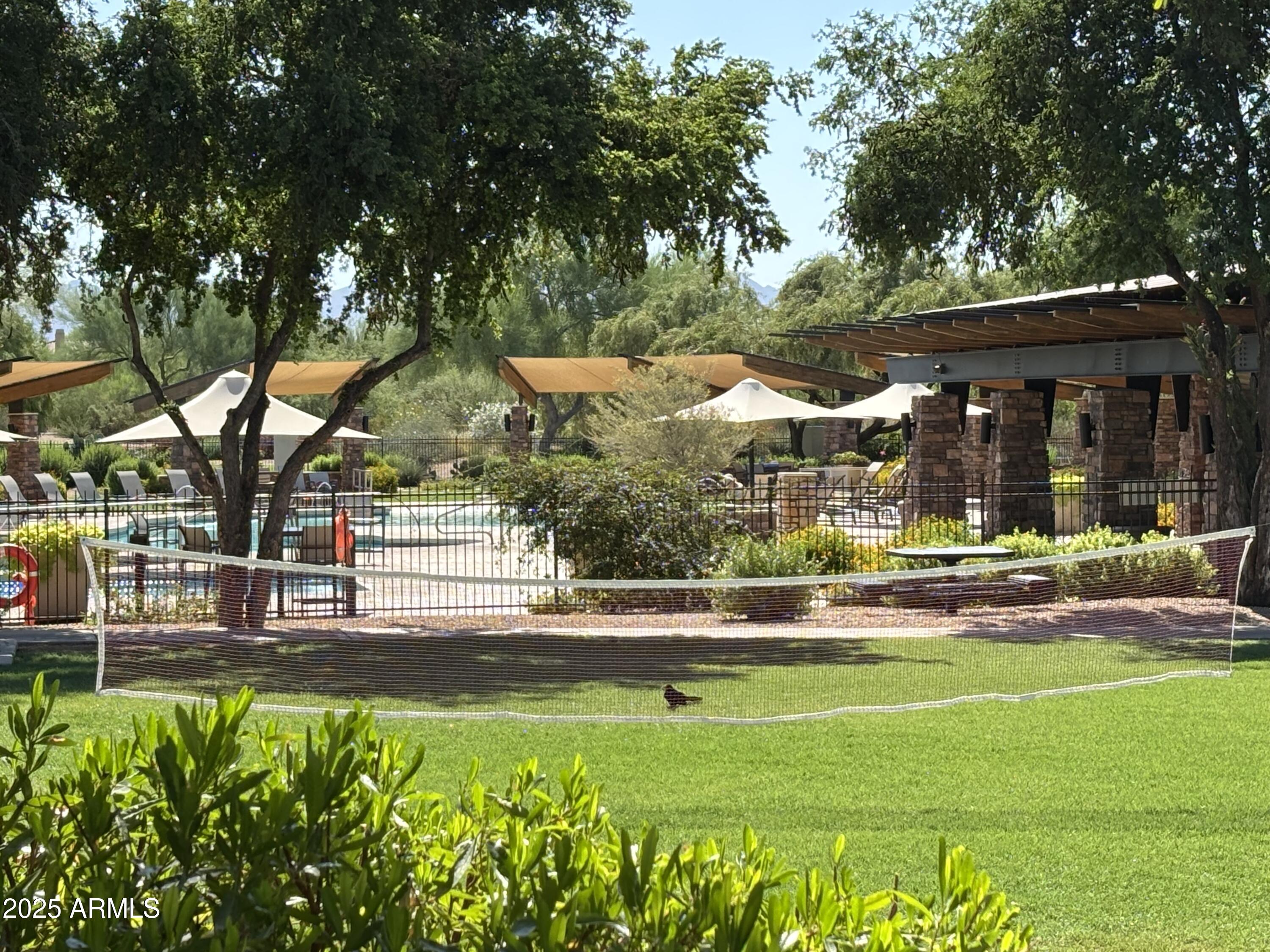 3935 East Rough Rider Road, Unit 1014 Phoenix, AZ 85050 - Photo 37 of 40 a view of swimming pool and trees in the background