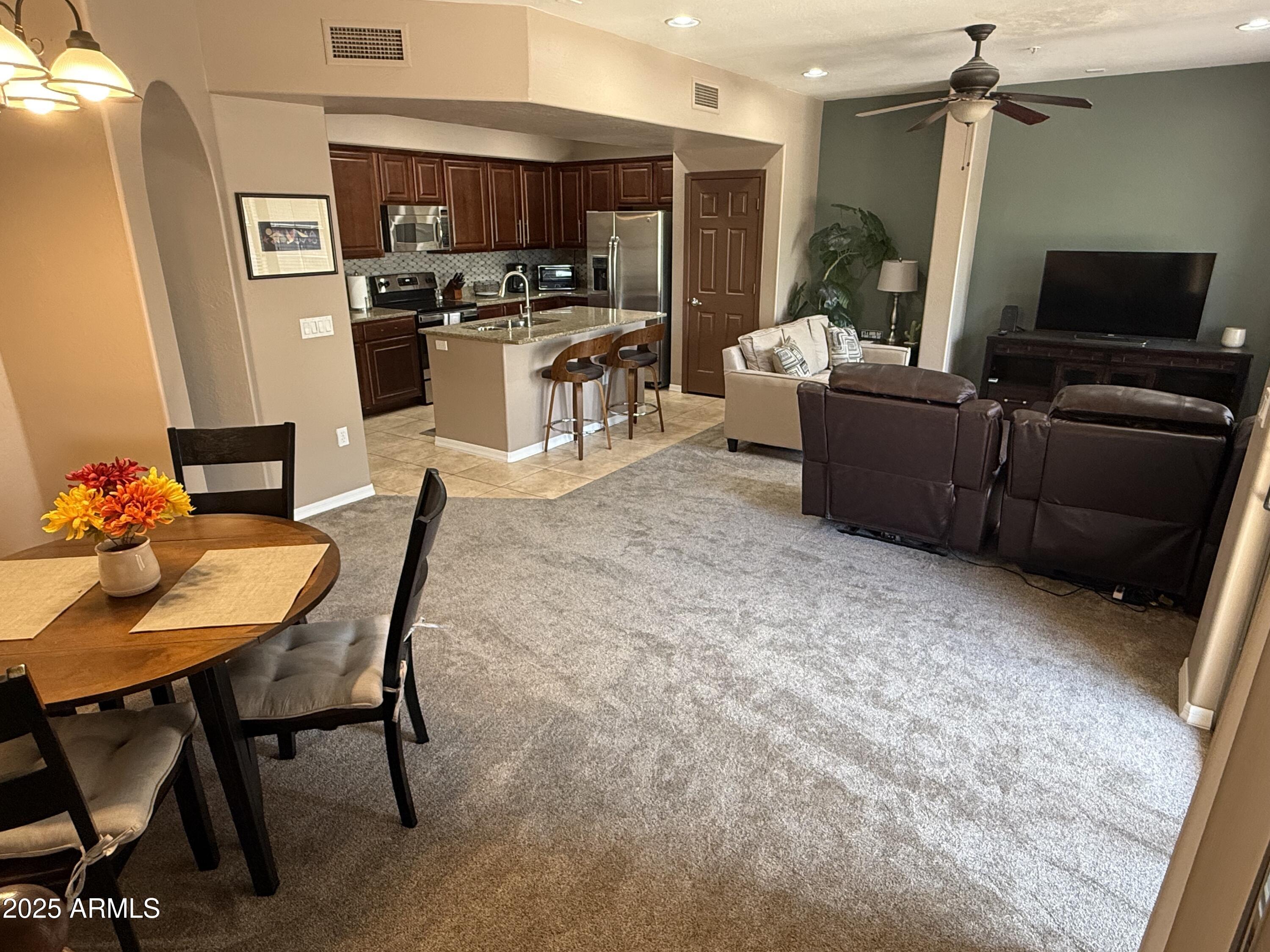 3935 East Rough Rider Road, Unit 1014 Phoenix, AZ 85050 - Photo 4 of 40 a living room with furniture and a flat screen tv