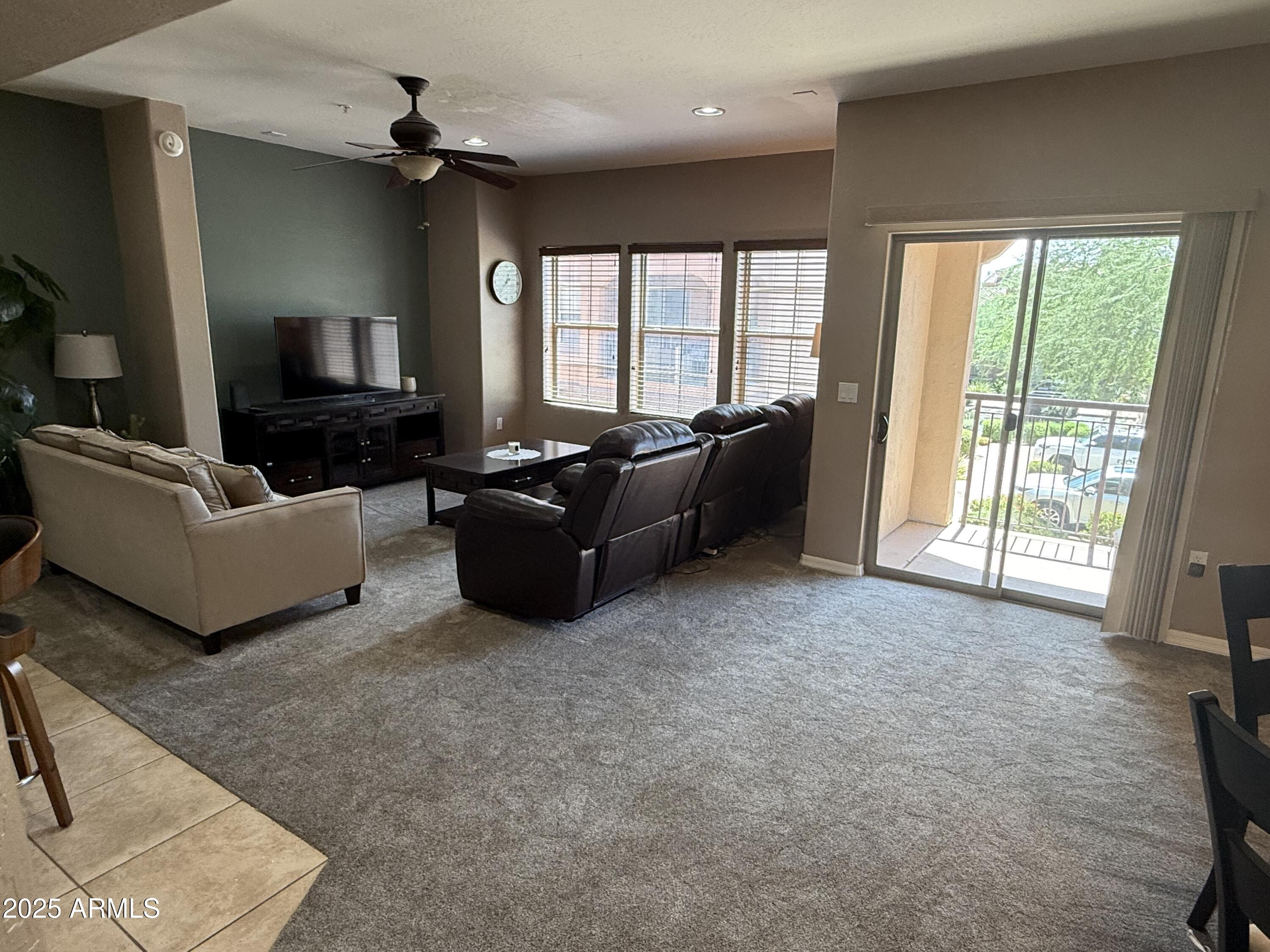 3935 East Rough Rider Road, Unit 1014 Phoenix, AZ 85050 - Photo 7 of 40 a living room with furniture and a flat screen tv