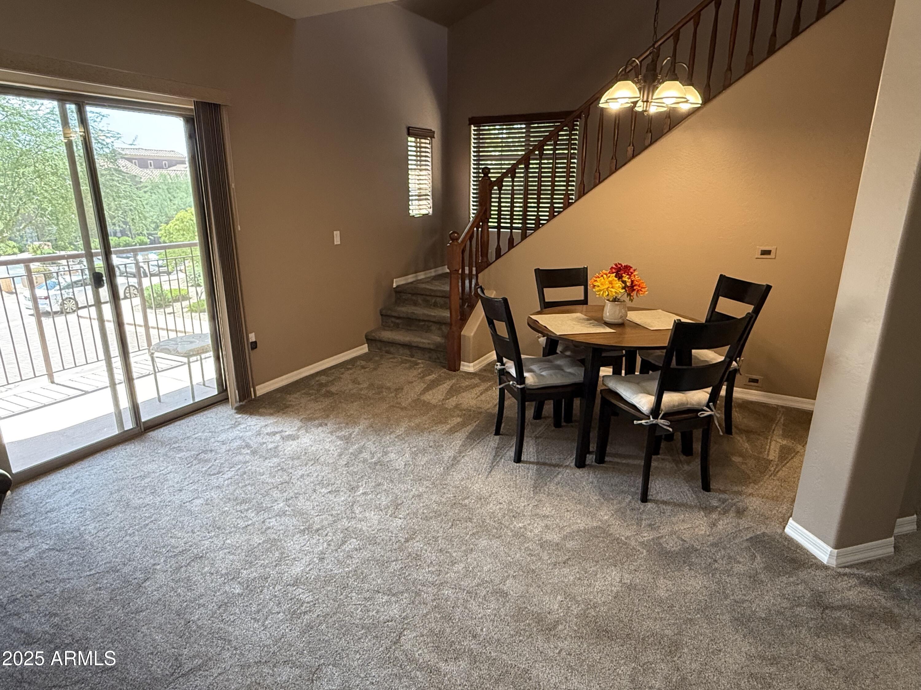 3935 East Rough Rider Road, Unit 1014 Phoenix, AZ 85050 - Photo 10 of 40 a view of a dining room with furniture window and outside view