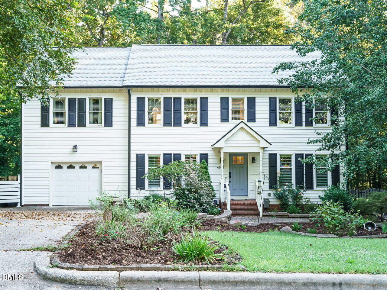 4104 Betterton Drive Raleigh, NC 27613 - Photo 1 of 32 a front view of a house with a yard and potted plants