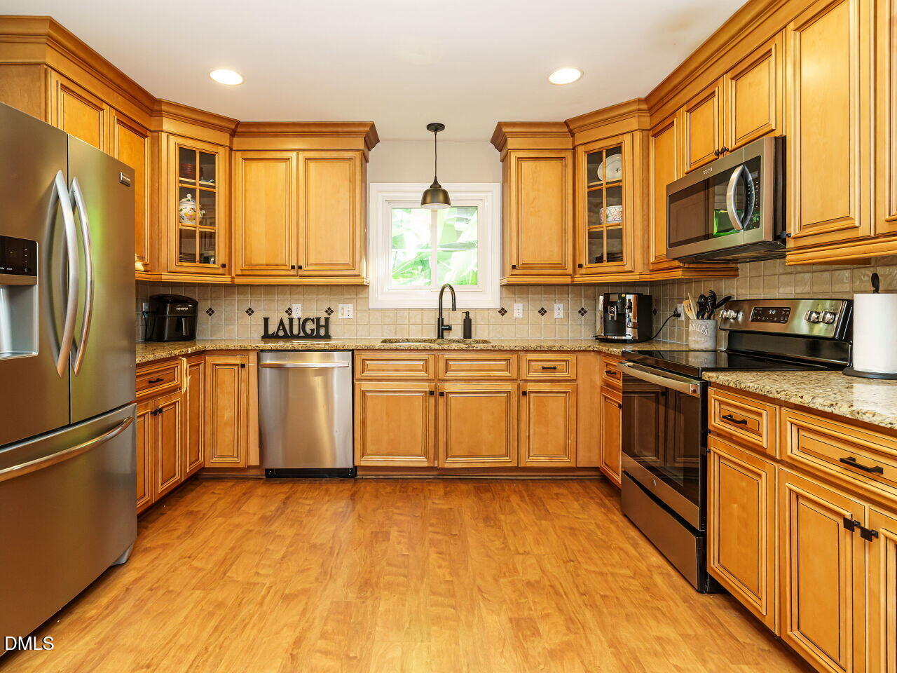 4104 Betterton Drive Raleigh, NC 27613 - Photo 11 of 32 a kitchen with a sink stove cabinets and refrigerator