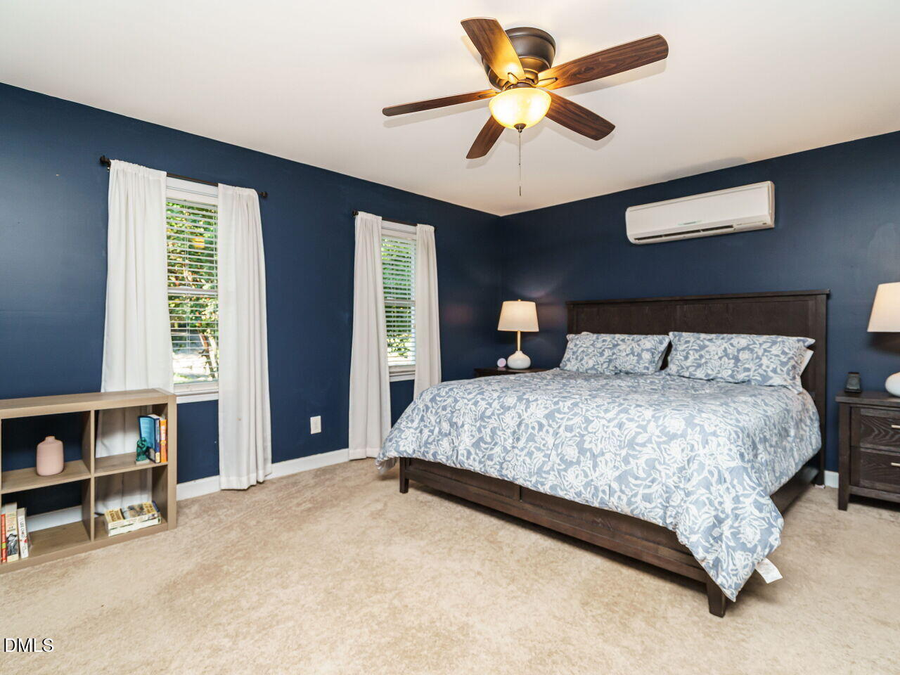 4104 Betterton Drive Raleigh, NC 27613 - Photo 15 of 32 a bedroom with a bed and a chandelier