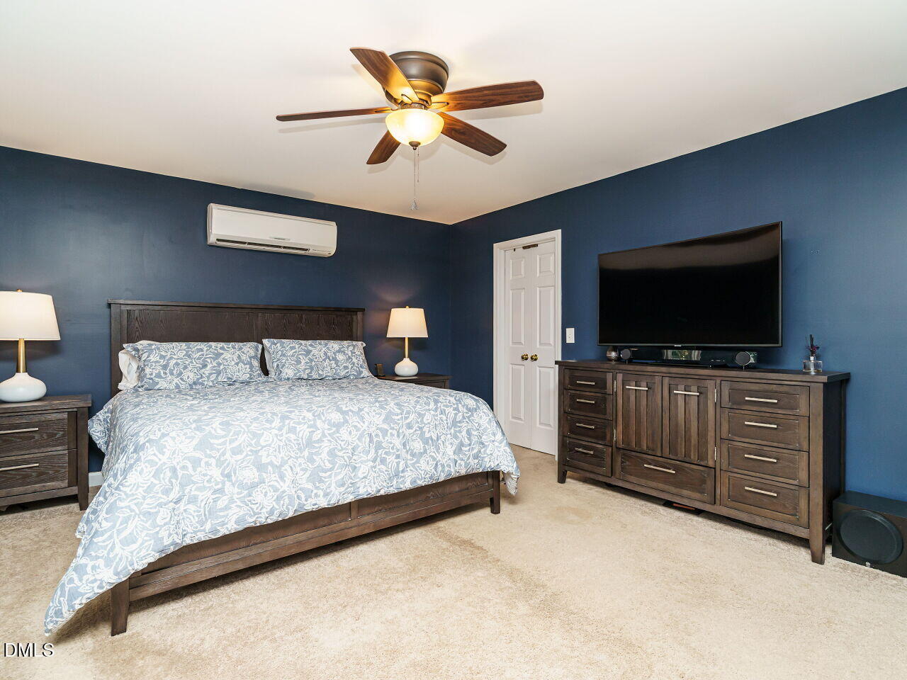 4104 Betterton Drive Raleigh, NC 27613 - Photo 16 of 32 a bedroom with a large bed and a flat screen tv