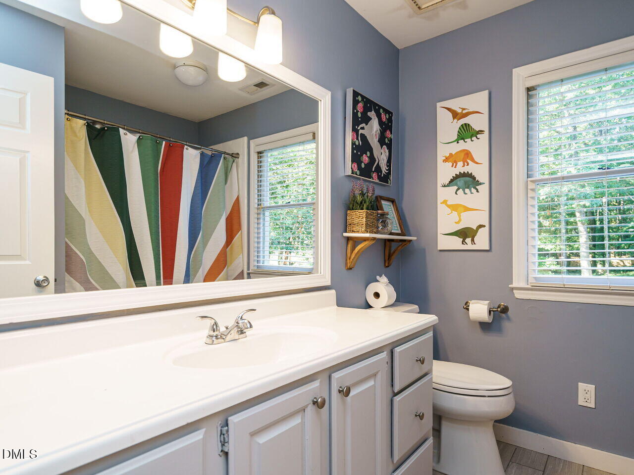 4104 Betterton Drive Raleigh, NC 27613 - Photo 21 of 32 a bathroom with a sink a toilet and a window