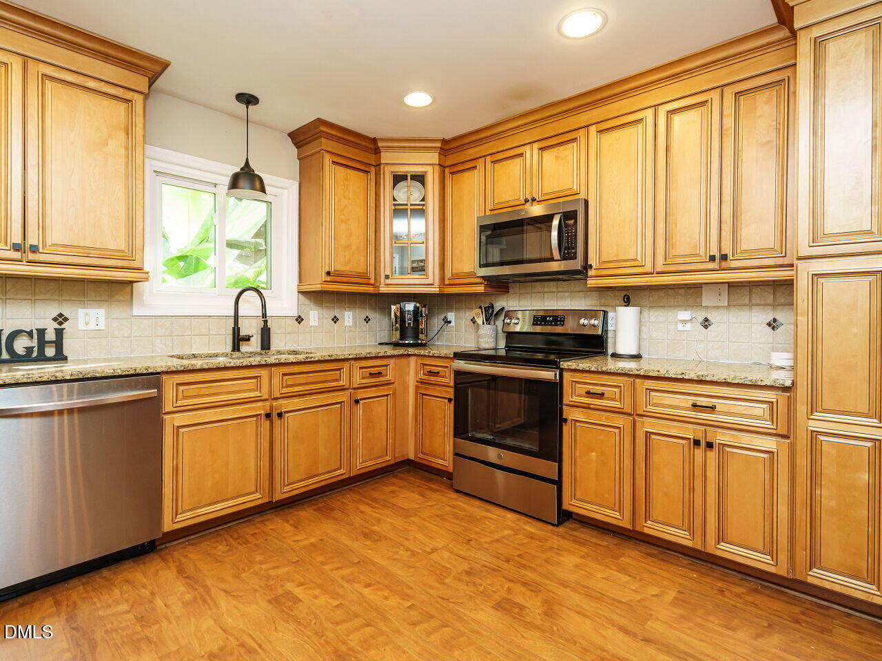4104 Betterton Drive Raleigh, NC 27613 - Photo 10 of 32 a kitchen with stainless steel appliances granite countertop a stove top oven a sink dishwasher a refrigerator and cabinets with wooden floor