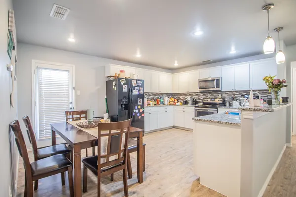 a stove top oven sitting inside of a kitchen