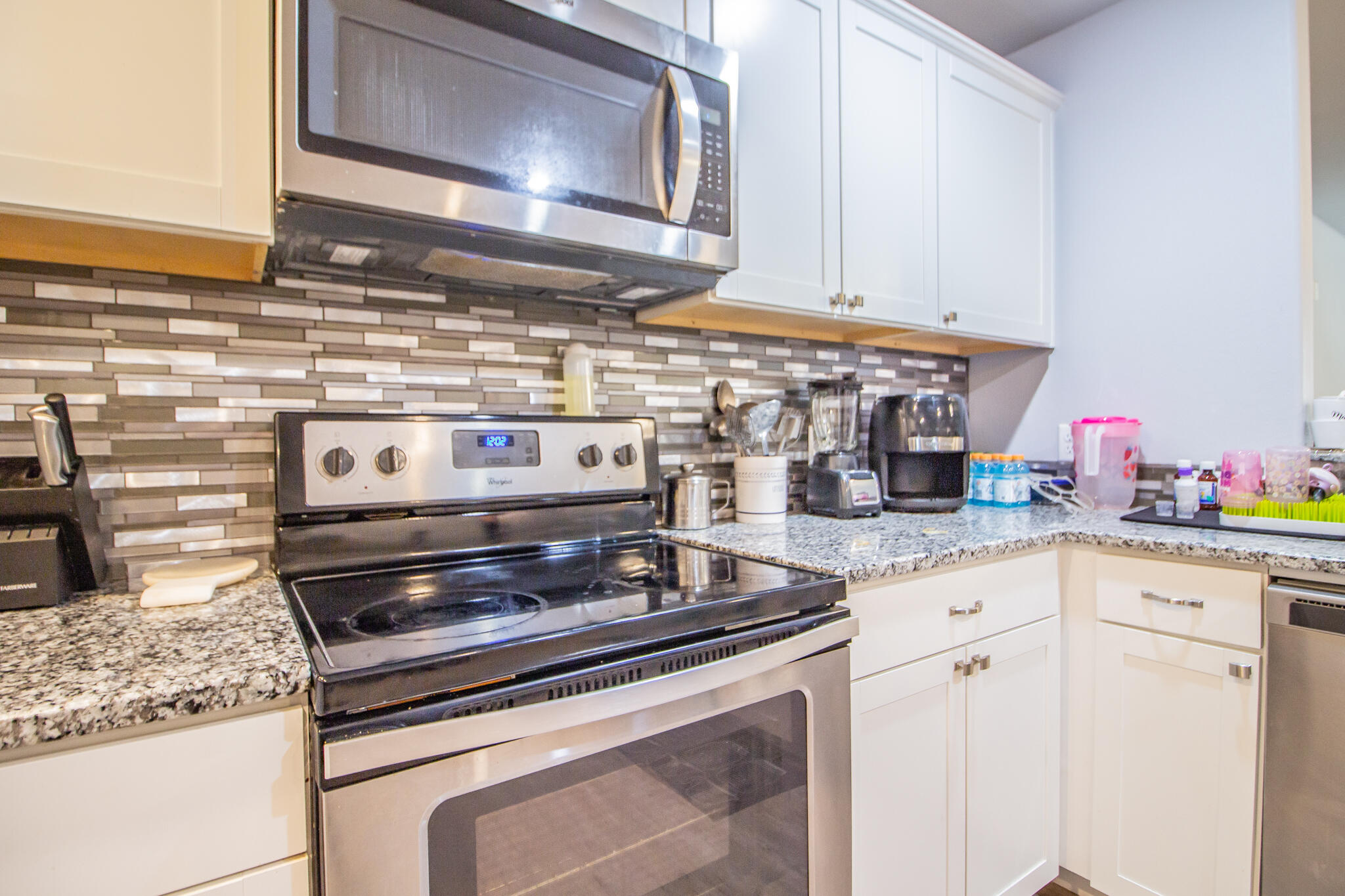 8812 15th Street Lubbock, TX 79416 - Photo 7 of 16 a stove top oven sitting inside of a kitchen