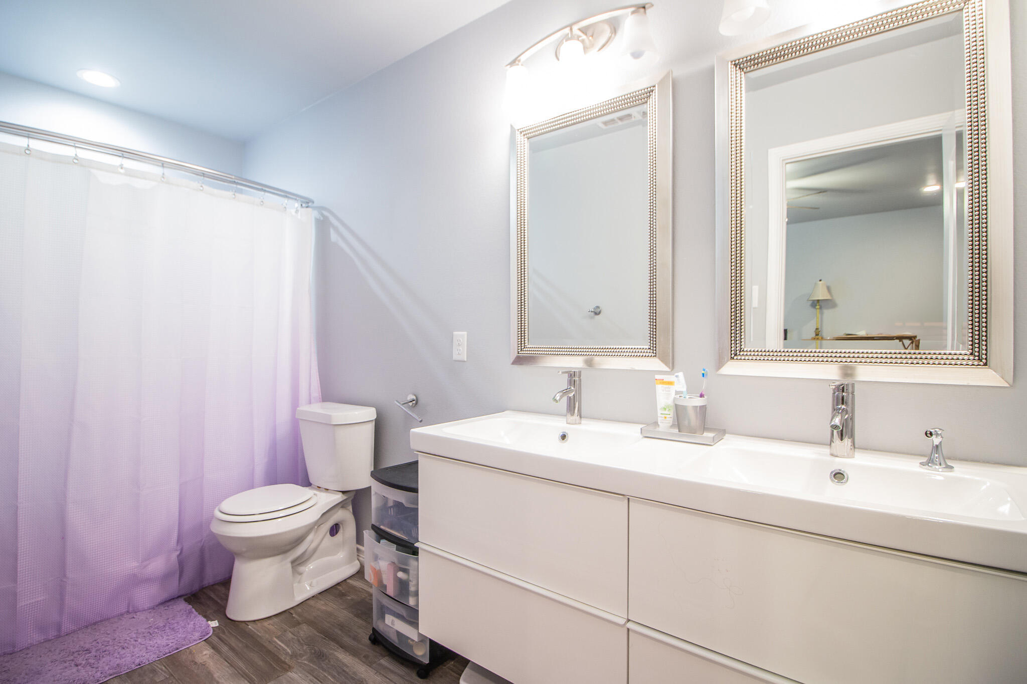 8812 15th Street Lubbock, TX 79416 - Photo 8 of 16 a bathroom with a double vanity sink mirror and toilet