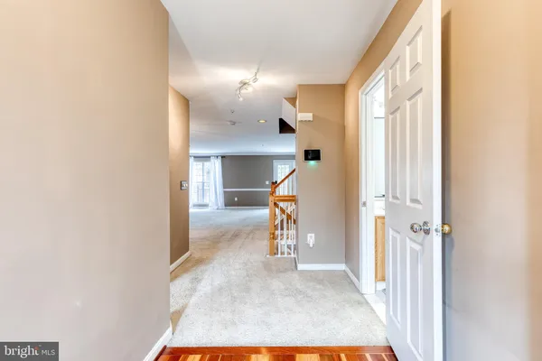 a view of a hallway view with wooden floor and staircase