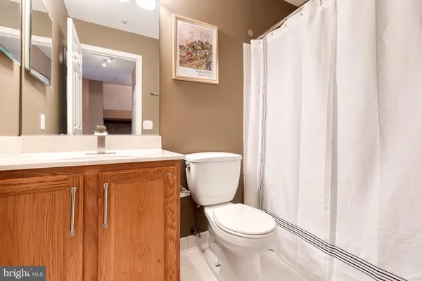a bathroom with a toilet a sink and a mirror