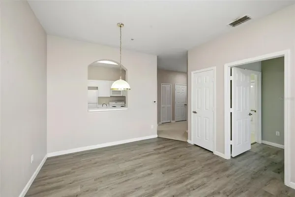 a kitchen with white cabinets and white appliances