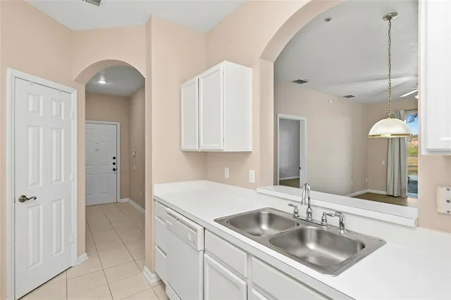 a kitchen with cabinets and white appliances