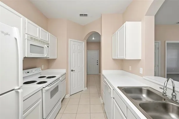 a kitchen with granite countertop a cabinets and appliances