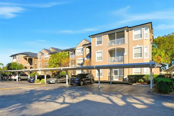 a view of a building with car parked