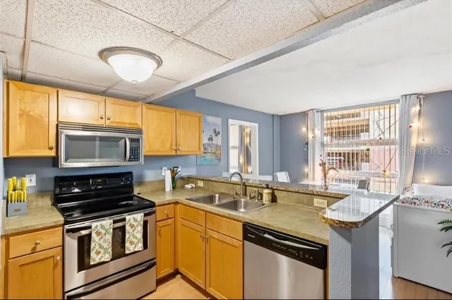 a kitchen that has a sink and a stove