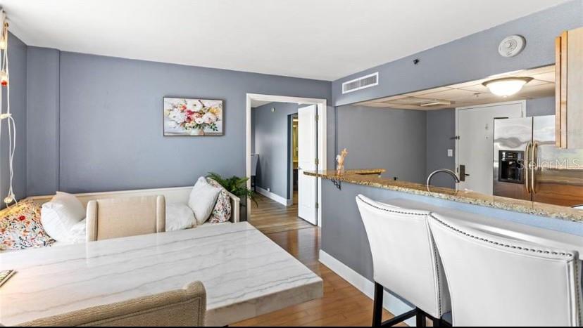 151 East Washington Street, Unit 611 Orlando, FL 32801 - Photo 10 of 21 a bedroom with a bed and a large mirror on dresser