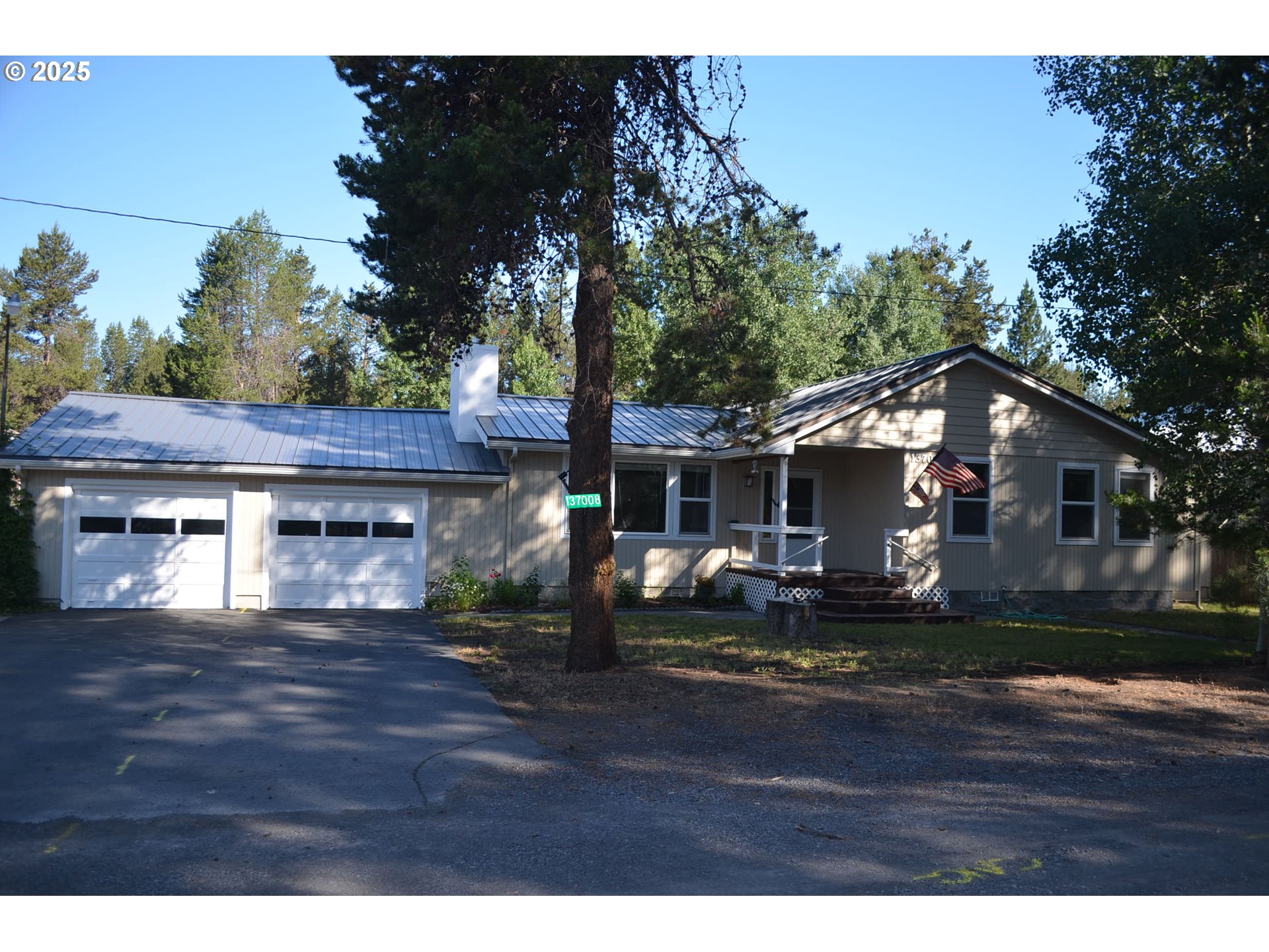a front view of house with yard and trees