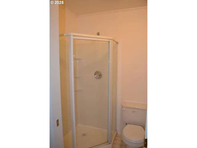 a bathroom with a toilet a sink and shower