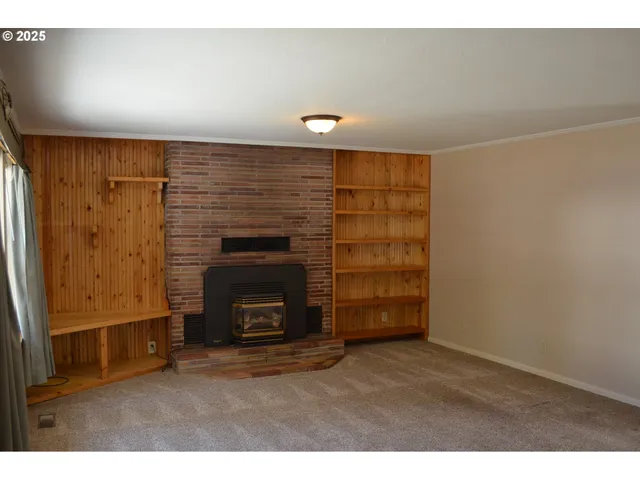 a view of an empty room and fire place