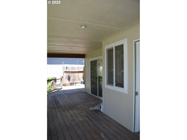 a view of a living room with a sink and wooden floor