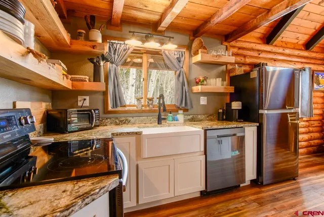 a kitchen with cabinets and stainless steel appliances
